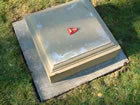The bottom section of the plinth is then placed on the paving stone, lined up accurately with the pencil line, and cemented into position. 