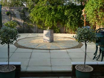 Staainless sundial on a four-legged plinth