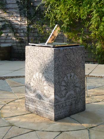 stainless sundial showing clear reflections in the polished surface