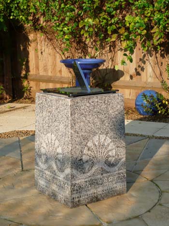 stainless sundial showing clear reflections in the polished surface