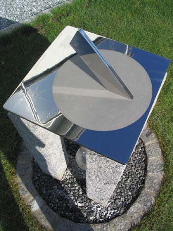 stainless sundial showing clear reflections in the polished surface